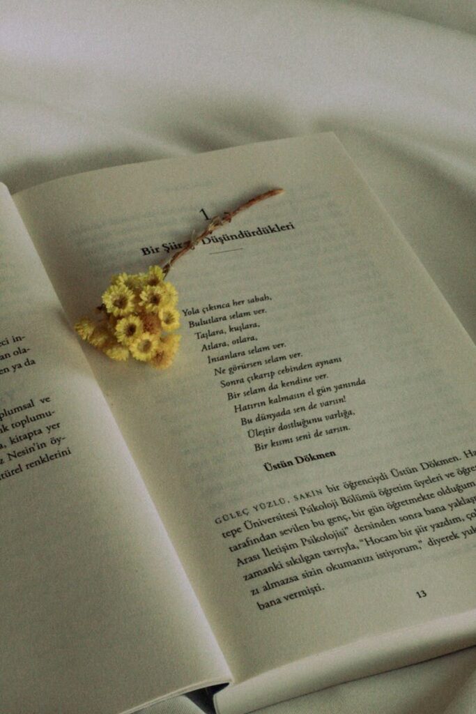 An open book with a yellow flower bouquet on the pages.